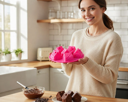 Femme souriante tenant un moule en silicone rose avec maisons